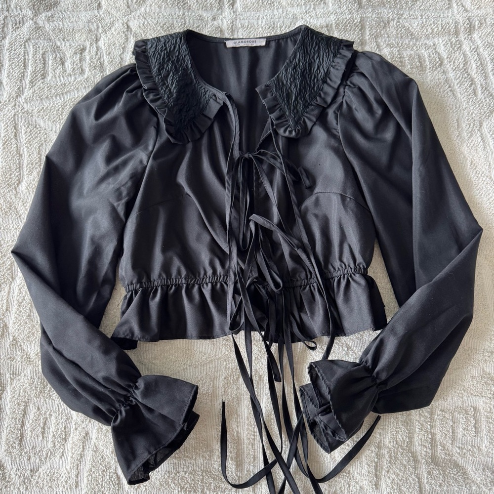 glamorous black top with tie detail and exaggerated collar